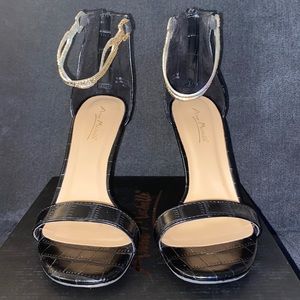 Black heels with gold ankle strap